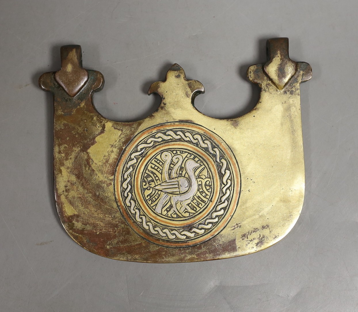 An Islamic bronze and mixed metal pendant, 10 cms wide